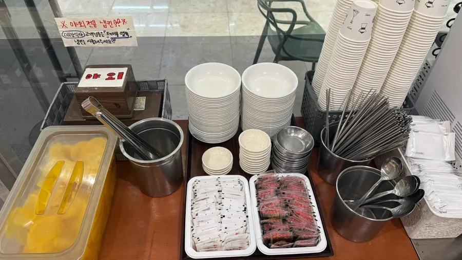 Self-serve bar with soy sauce, salt, and pickled radish