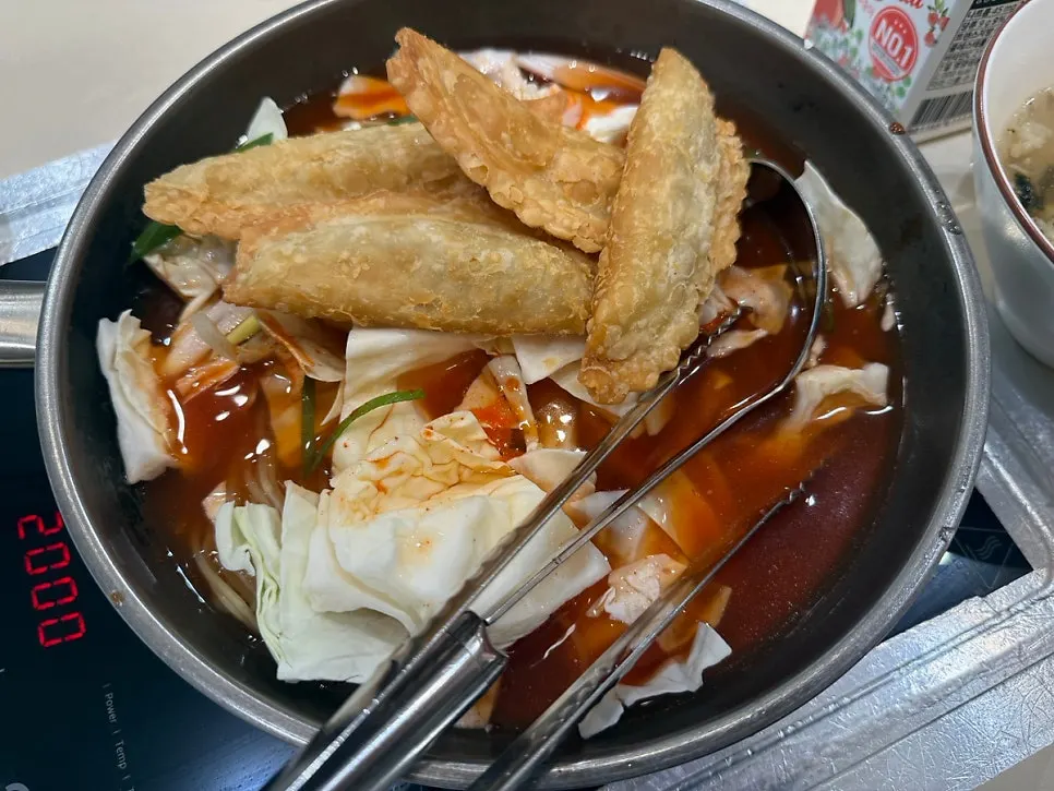 Instant tteokbokki ingredients with a cup of Coolpis