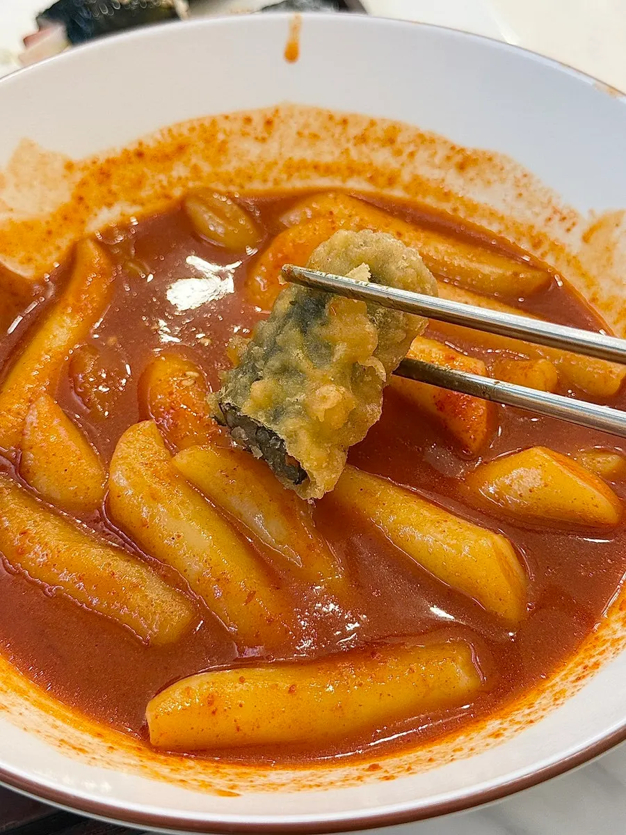 Fried snacks dipped in tteokbokki sauce