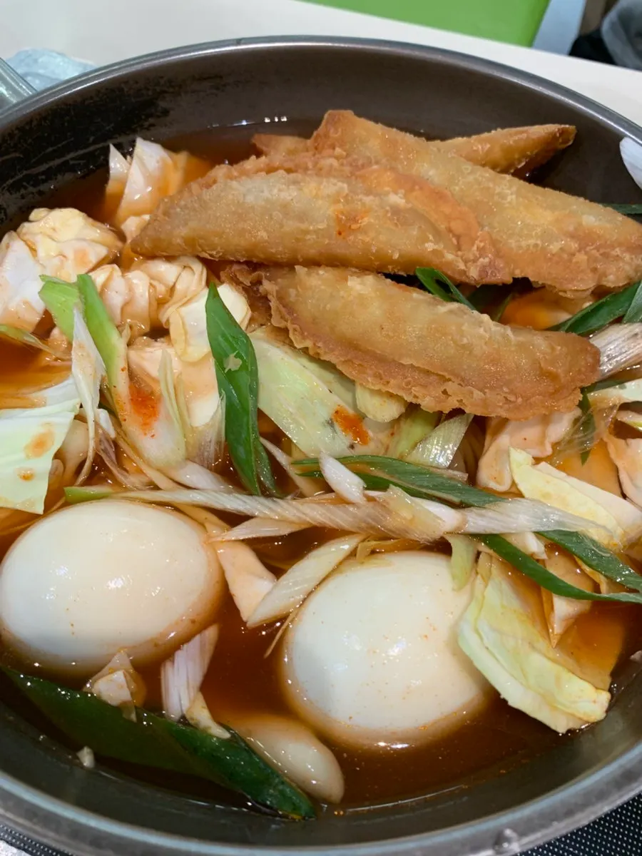 Pot of instant tteokbokki loaded with toppings