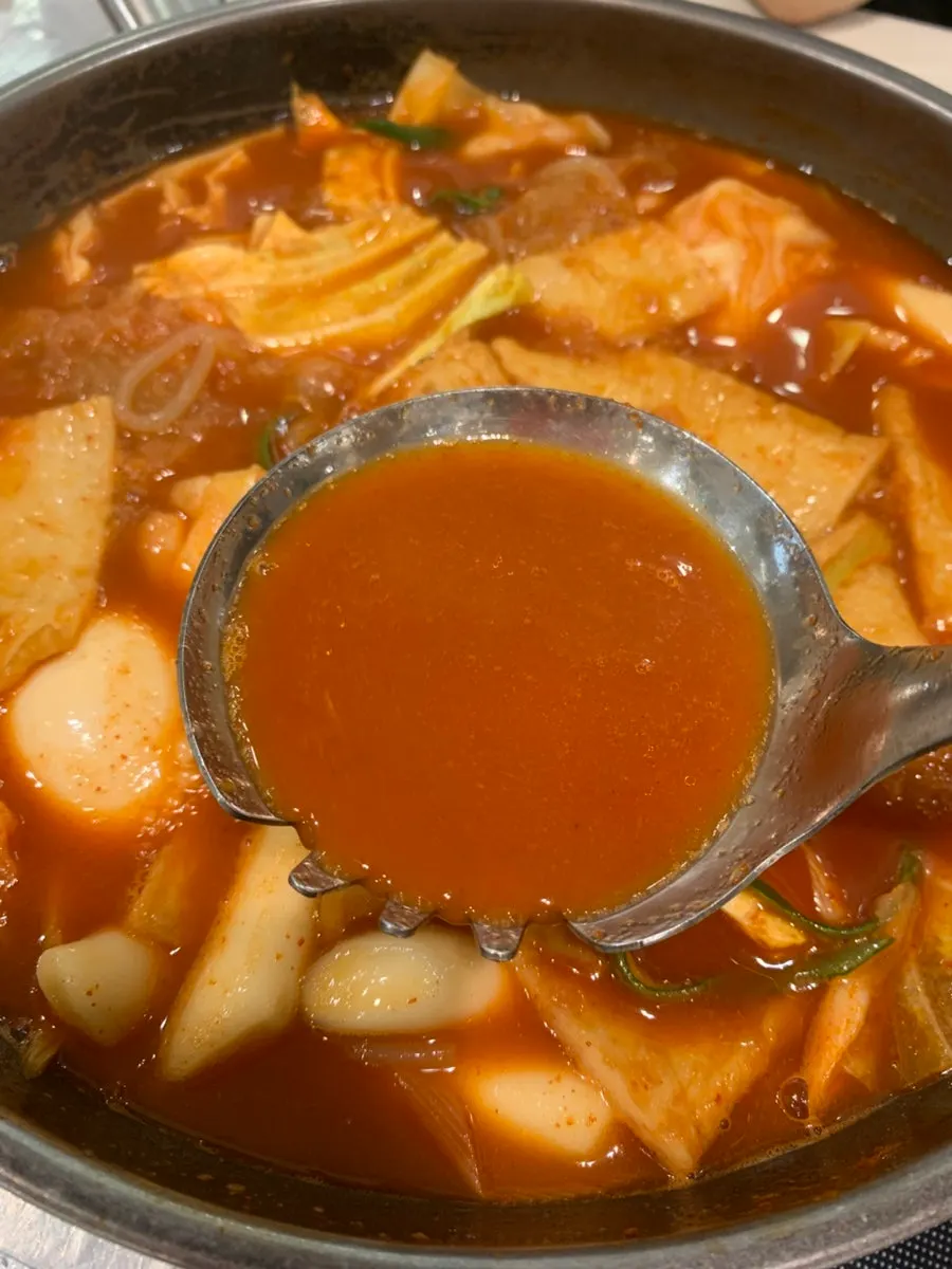 Chewy tteokbokki rice cakes submerged in broth