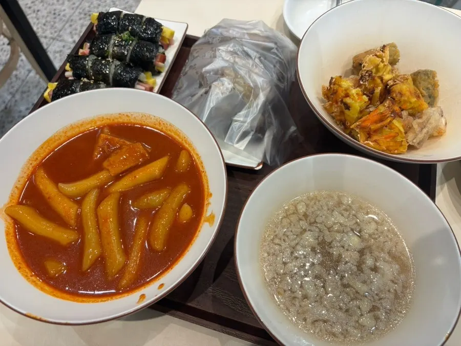 꼬마김밥과 떡볶이를 함께 먹는 모습