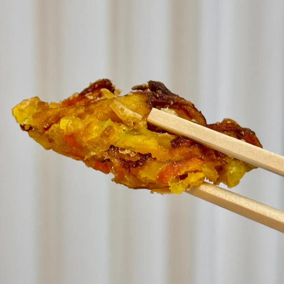 Crispy fritter dipped in tteokbokki sauce