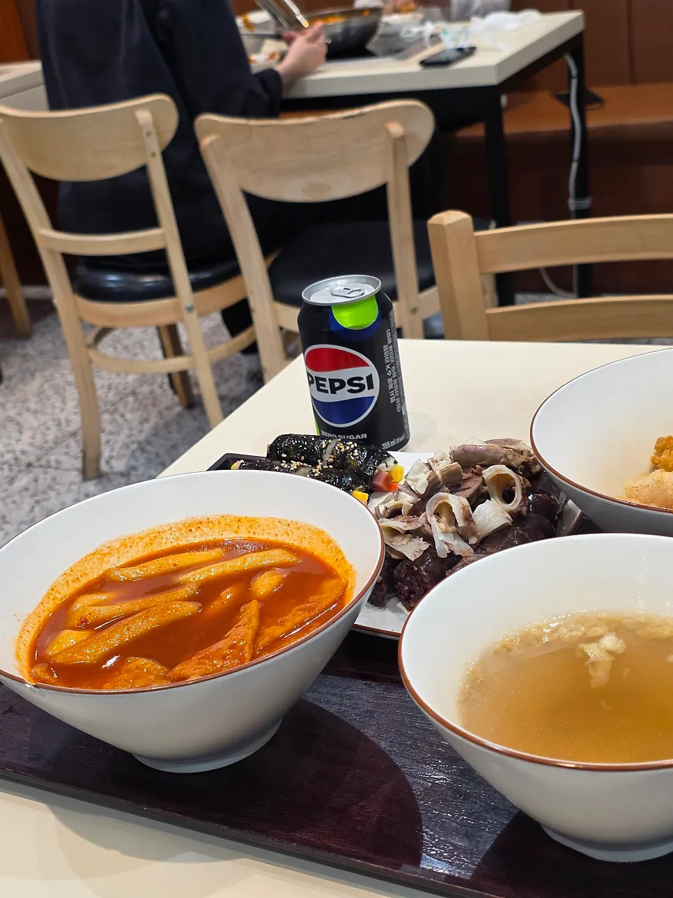 Table setting with tteokbokki, sundae, and fried snacks together