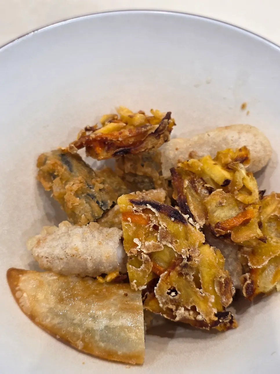 Mixed fried snacks with dumplings, vegetables, sweet potato, squid, and gimmari
