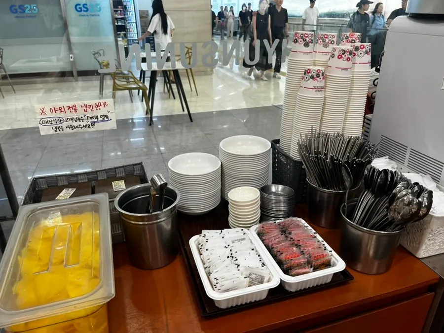 Self-serve bar with pickled radish and utensils