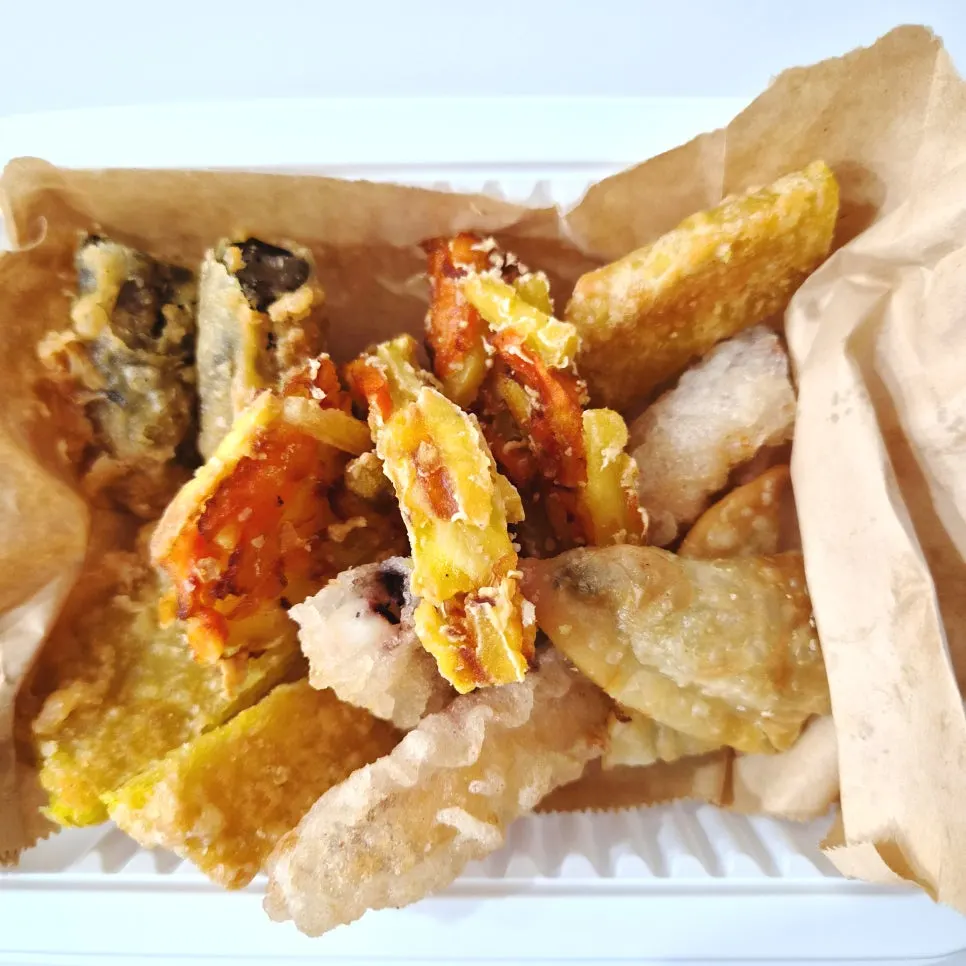 Assorted fried snacks including sweet potato fritter and gimmari