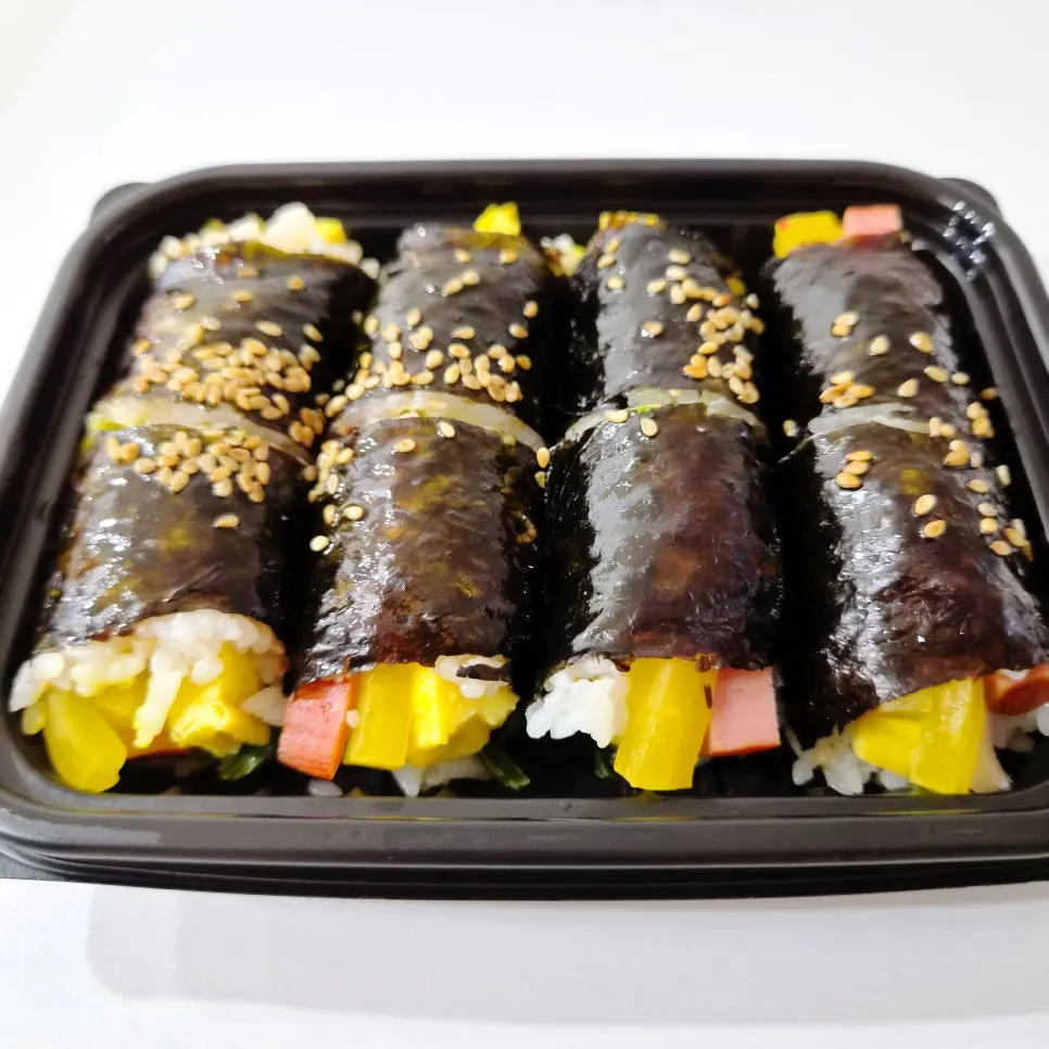 Mini gimbap in a takeout container