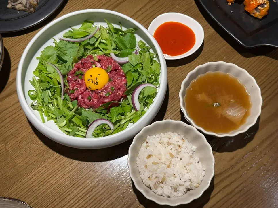 Minari hanwoo yukhoe bibimbap with doenjang soup table setting