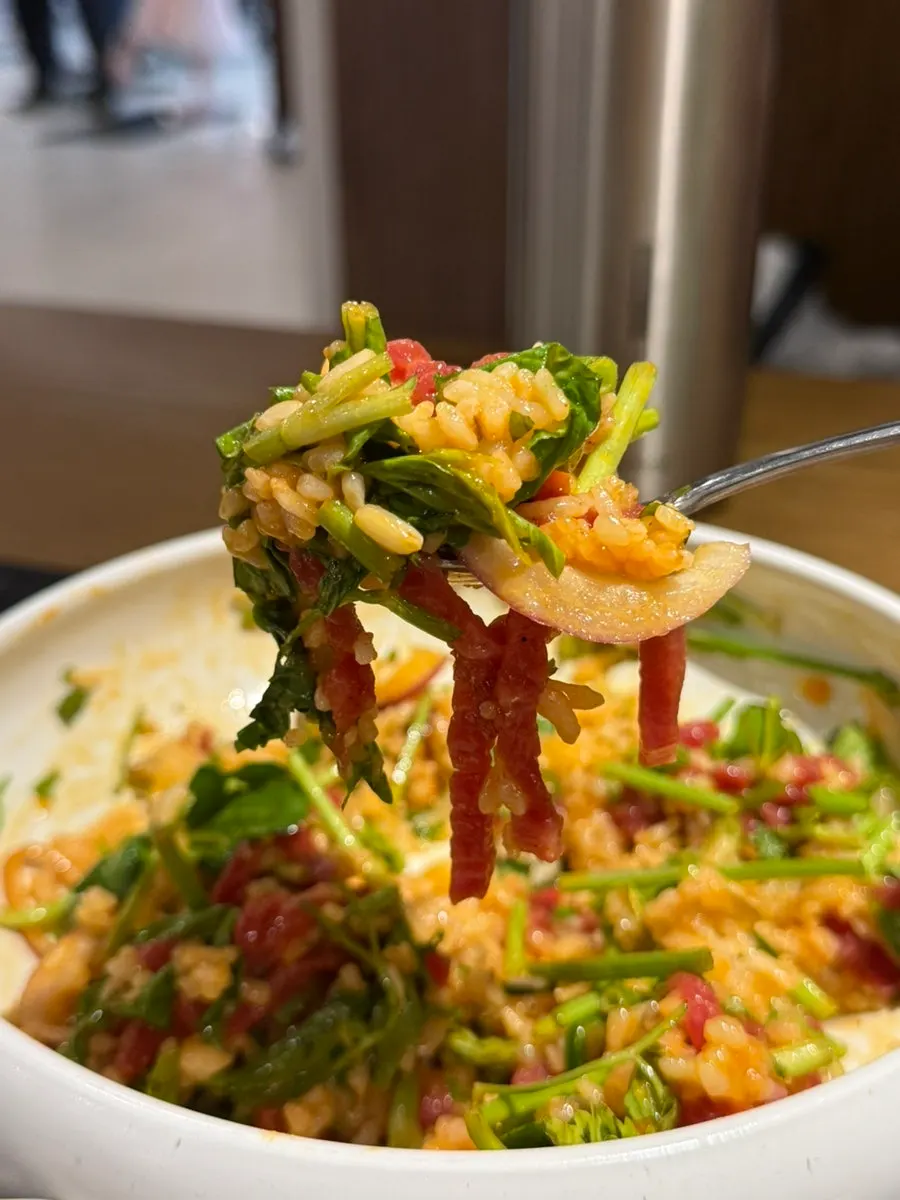 A bowl of mixed minari hanwoo yukhoe bibimbap