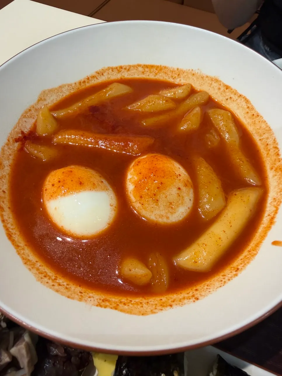 Extra-spicy tteokbokki with added egg and curly fish cake