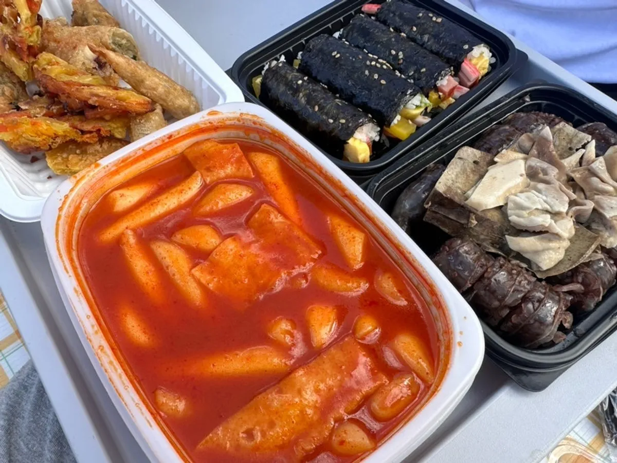 Full snack spread with tteokbokki, sundae, fried snacks, and gimbap