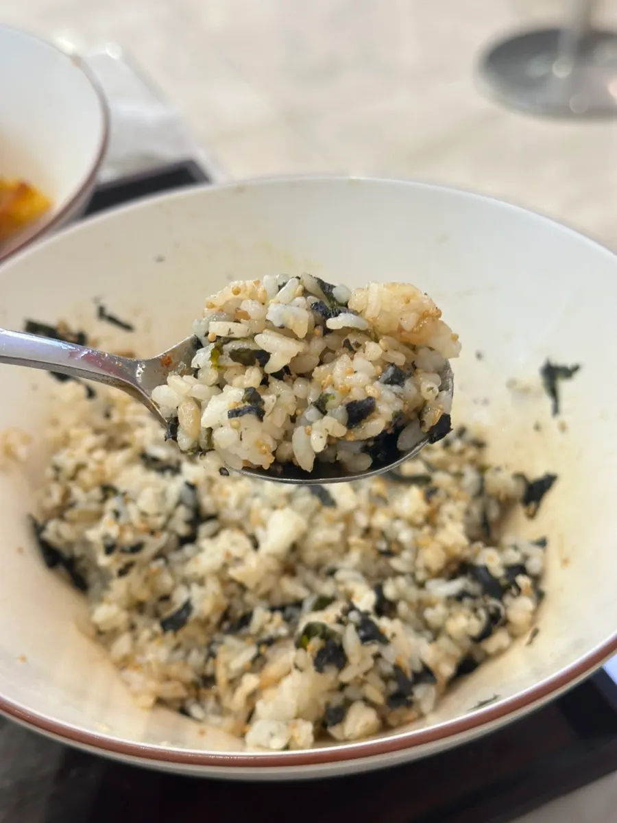 A spoonful of rice ball eaten alongside tteokbokki