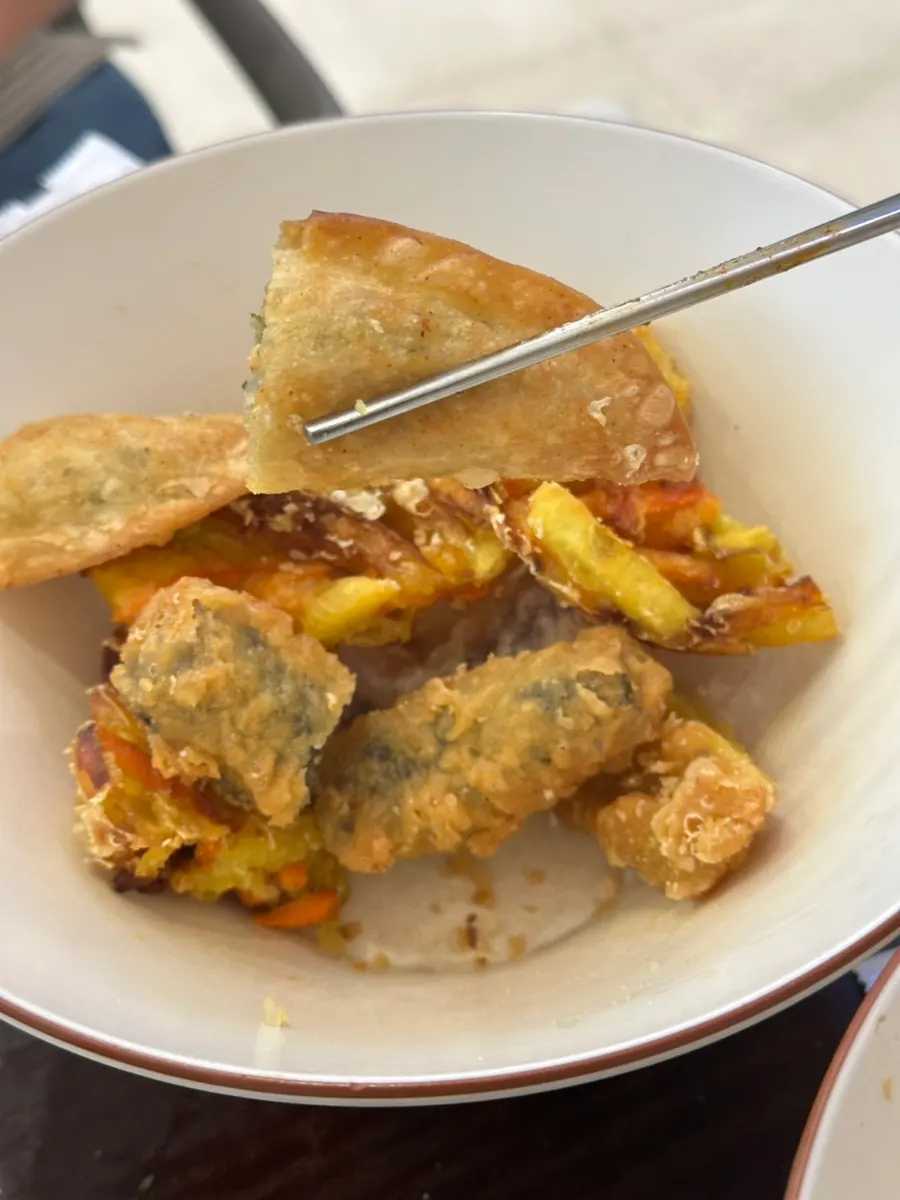 Crispy fried snack dipped in tteokbokki sauce
