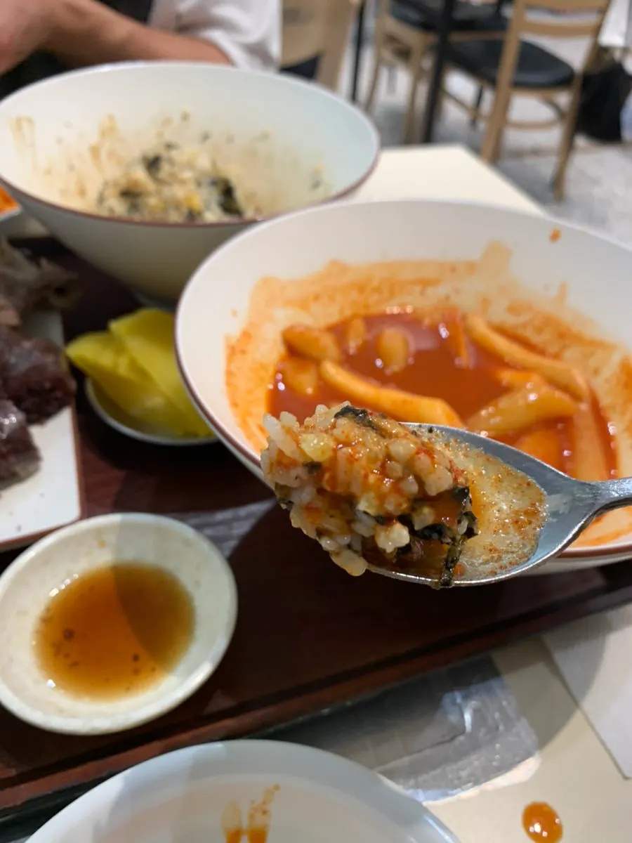 Fritter dipped into tteokbokki sauce