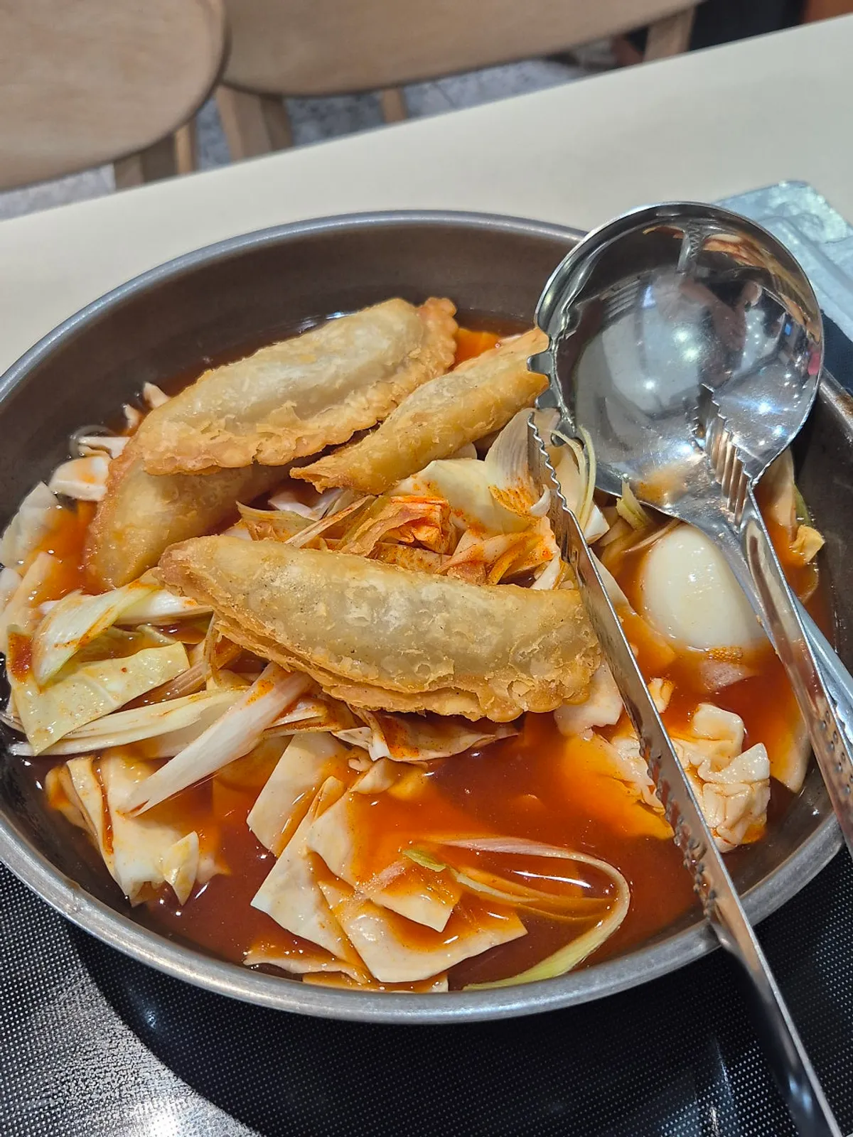 Pot of instant tteokbokki for two, packed with ingredients