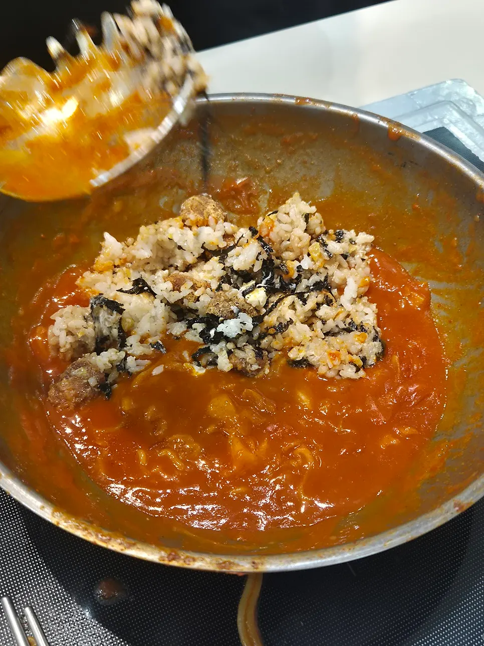 A spoonful of rice mixed with the sauce