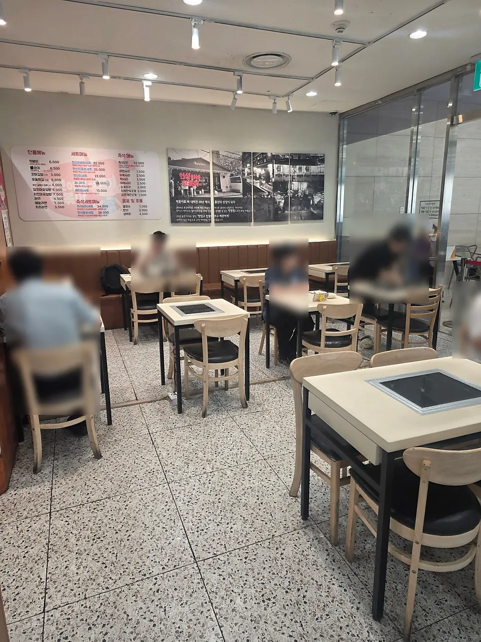 Interior of Hyeonseonine IFC Mall Branch with wood-toned tables