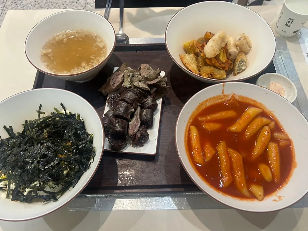 Self-serve bar with bowls, pickled radish, and sauces at Hyeonseonine