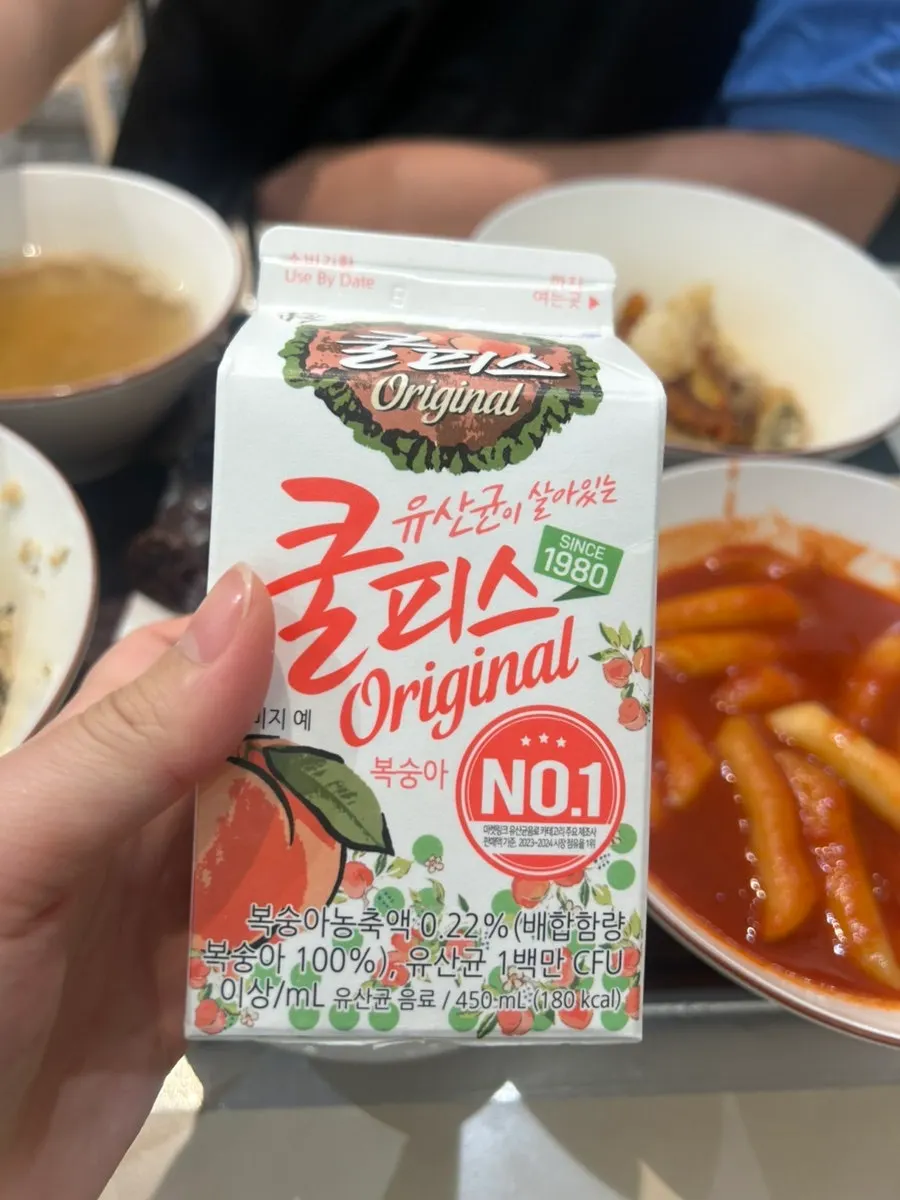 Fried snack dipped in tteokbokki sauce