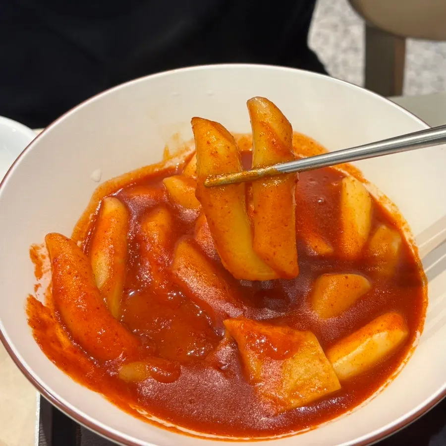 Close-up of chewy rice cake coated in sauce
