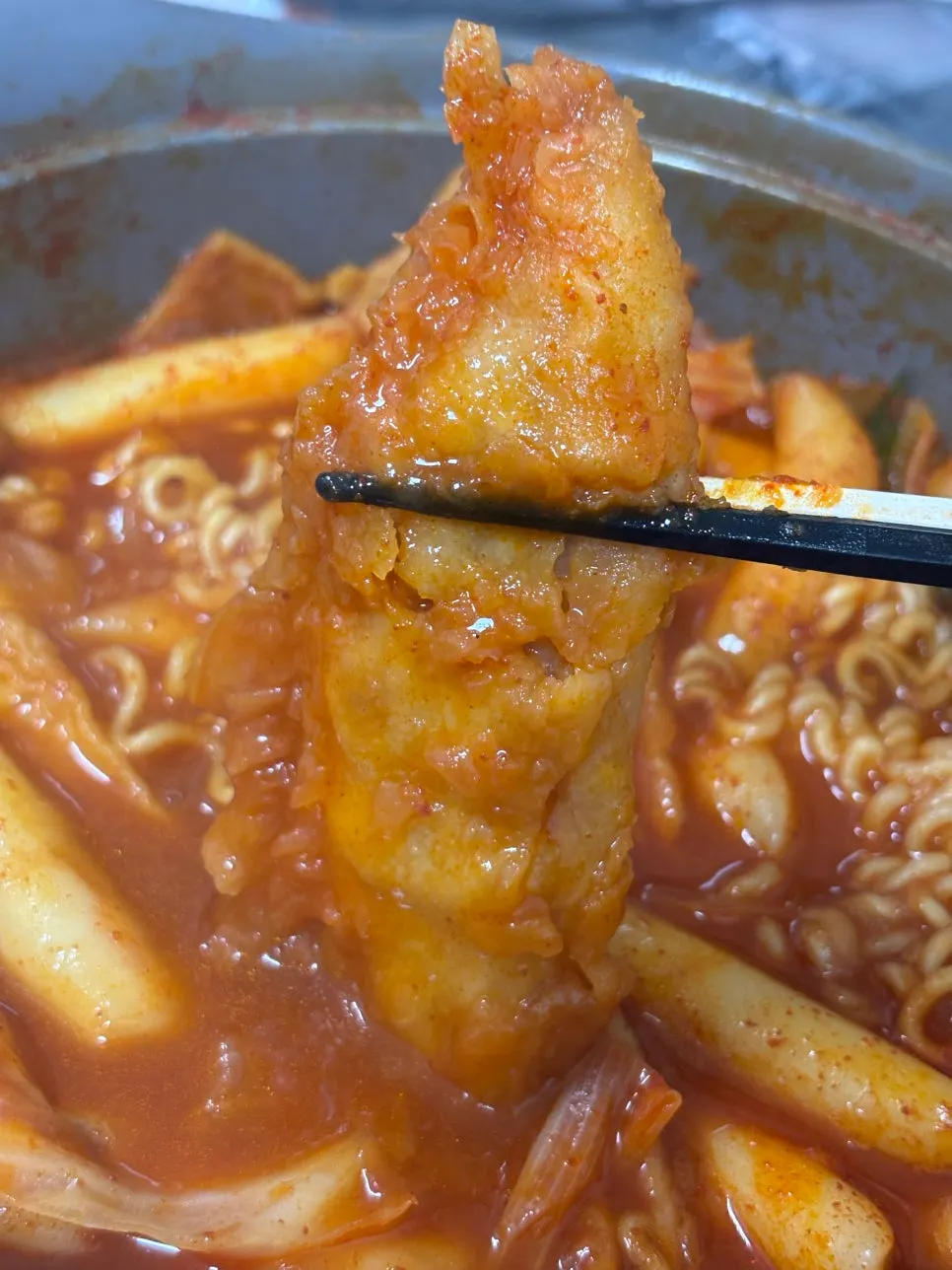 Two boiled eggs sitting in the sauce