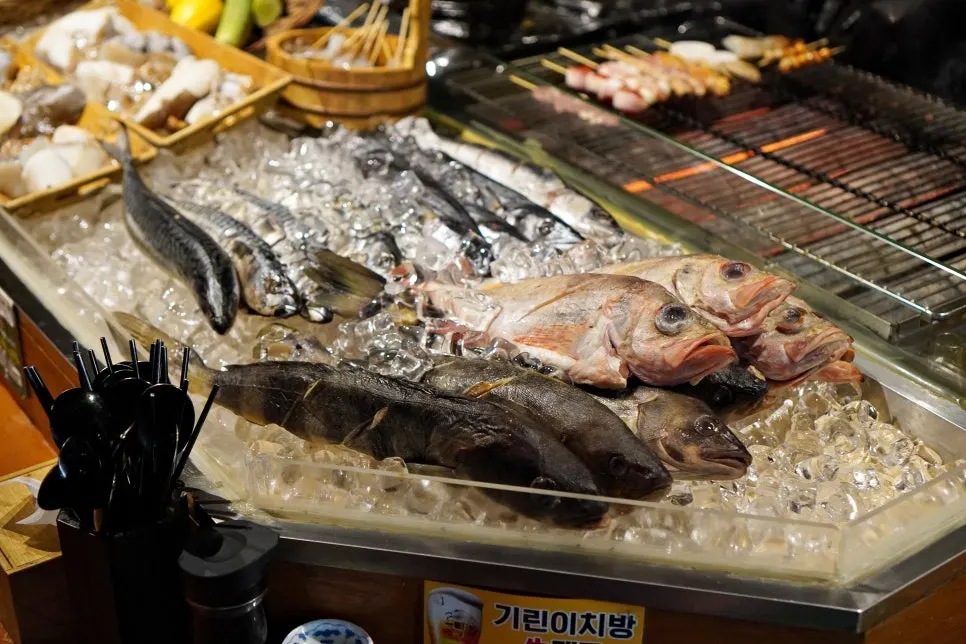 Fish and ingredients displayed at the front of the bar counter