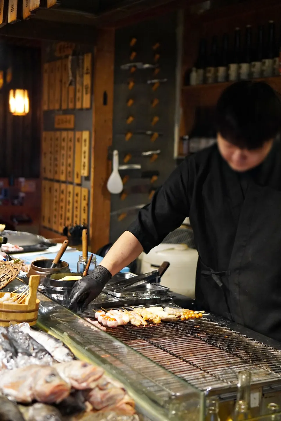 Staff grilling skewers in front of customers