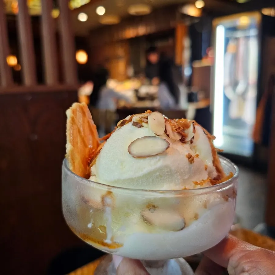 Ice cream topped with sliced almonds
