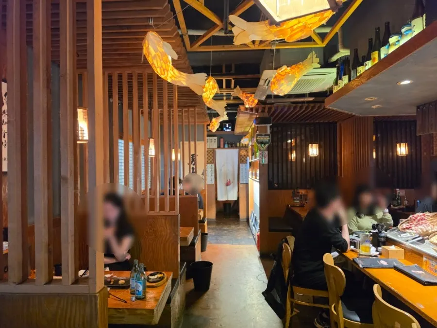 Izakaya interior with wood finishes and soft lighting