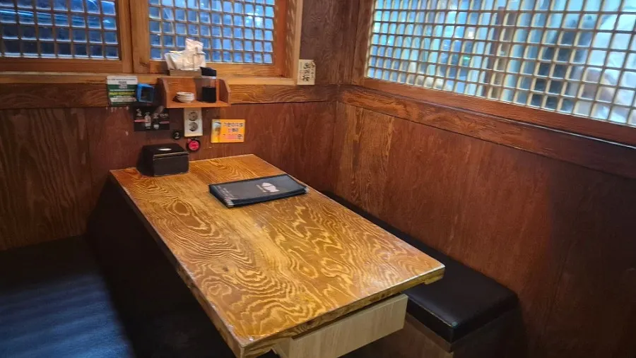 Table seats divided by wood partitions