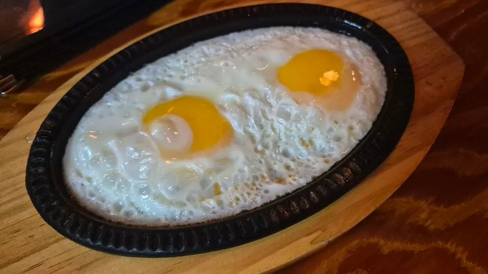 Pre-meal fried egg cooked on a griddle
