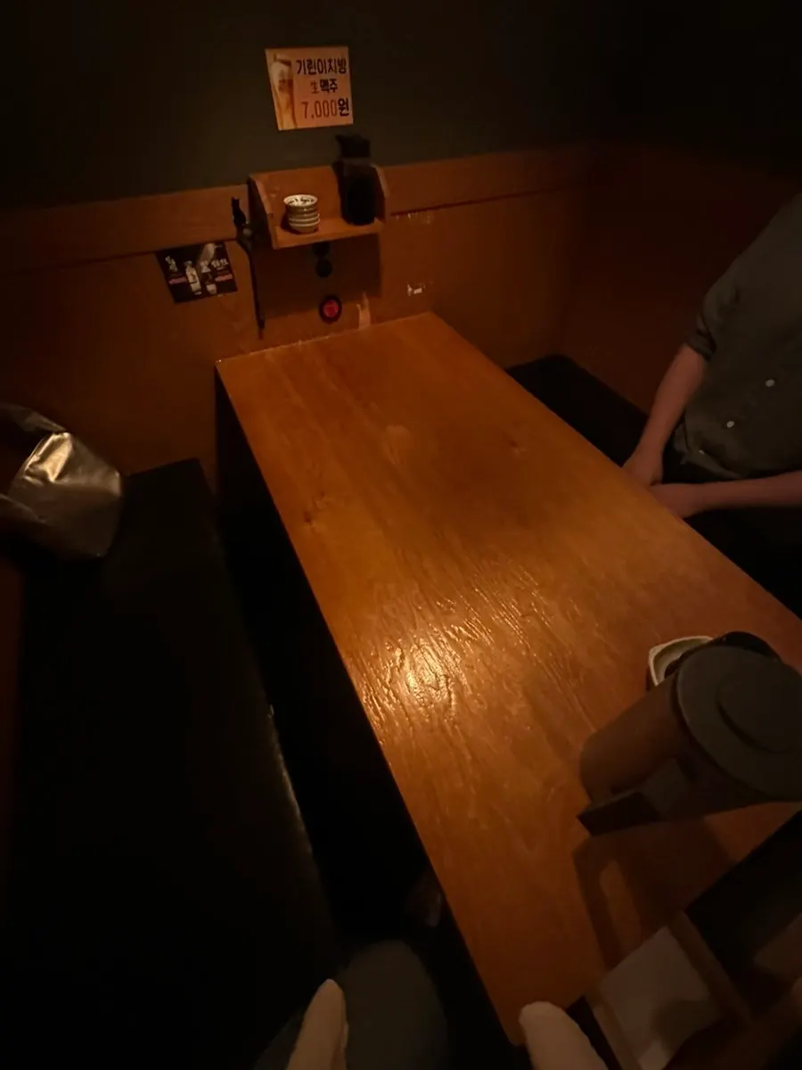 Dimly lit izakaya hall with wood tables
