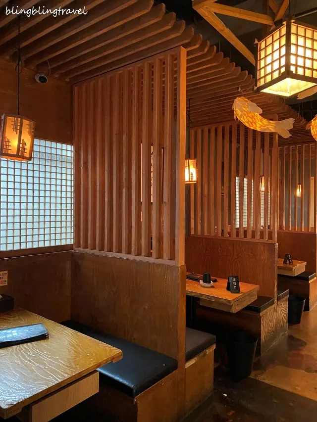 Wood-toned izakaya interior with soft lighting