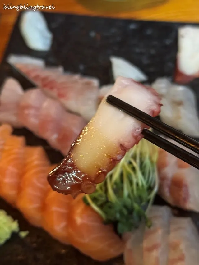 Octopus sashimi topped with wasabi