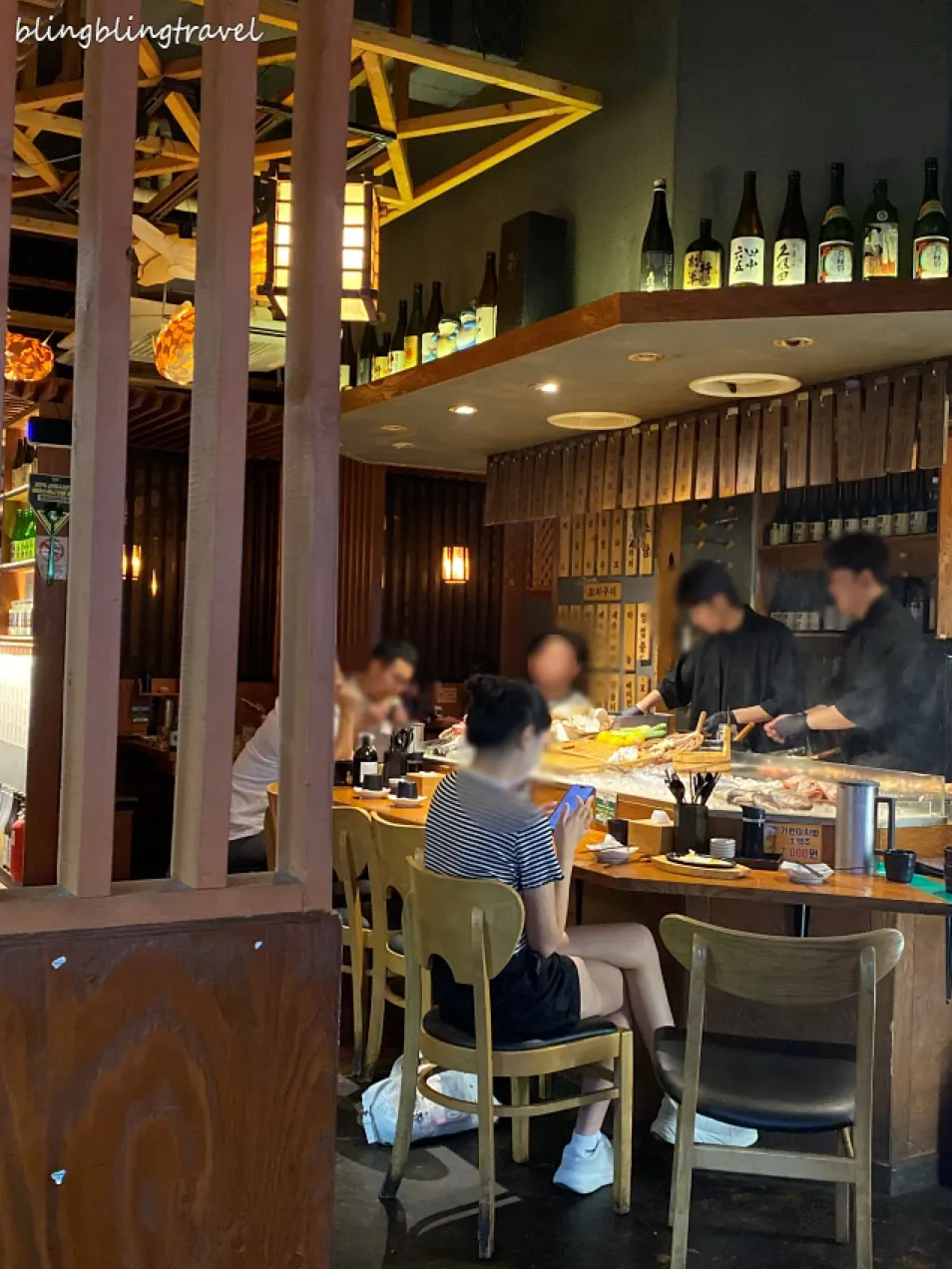 Table set with sashimi, skewers, and odeng nabe together
