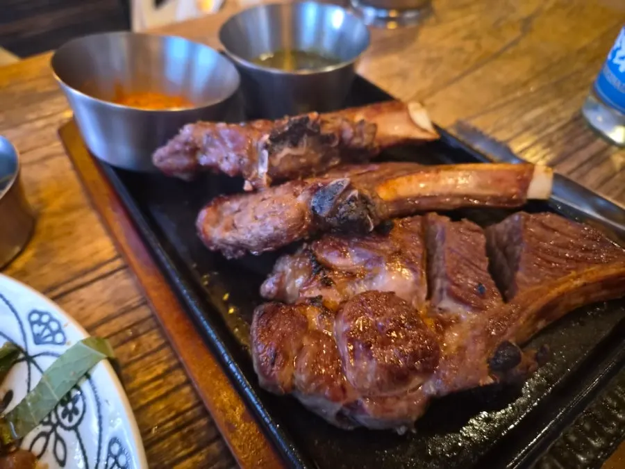 Premium lamb shoulder rack plated on a hot plate