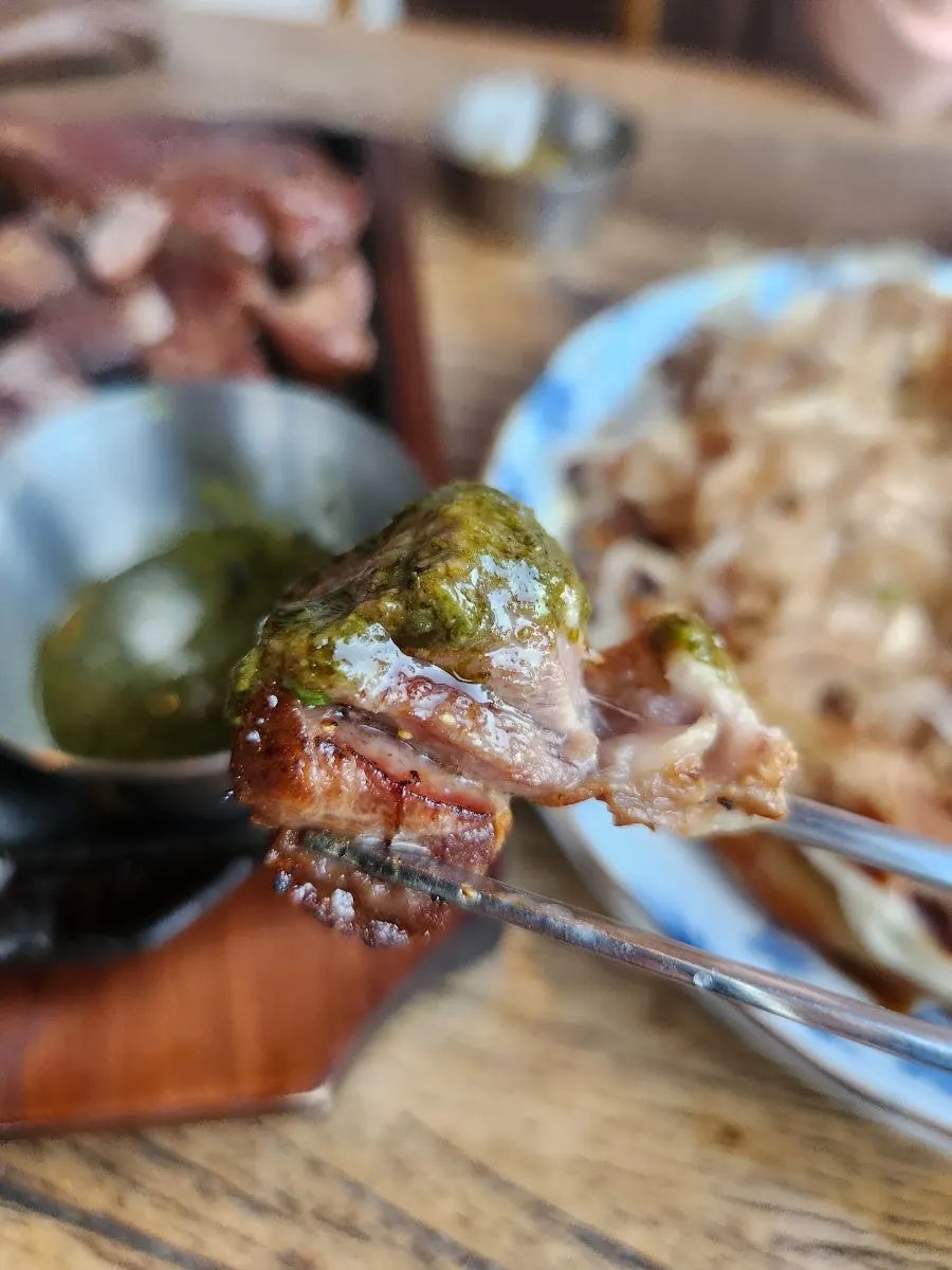Lamb shoulder rack dipped into sauce