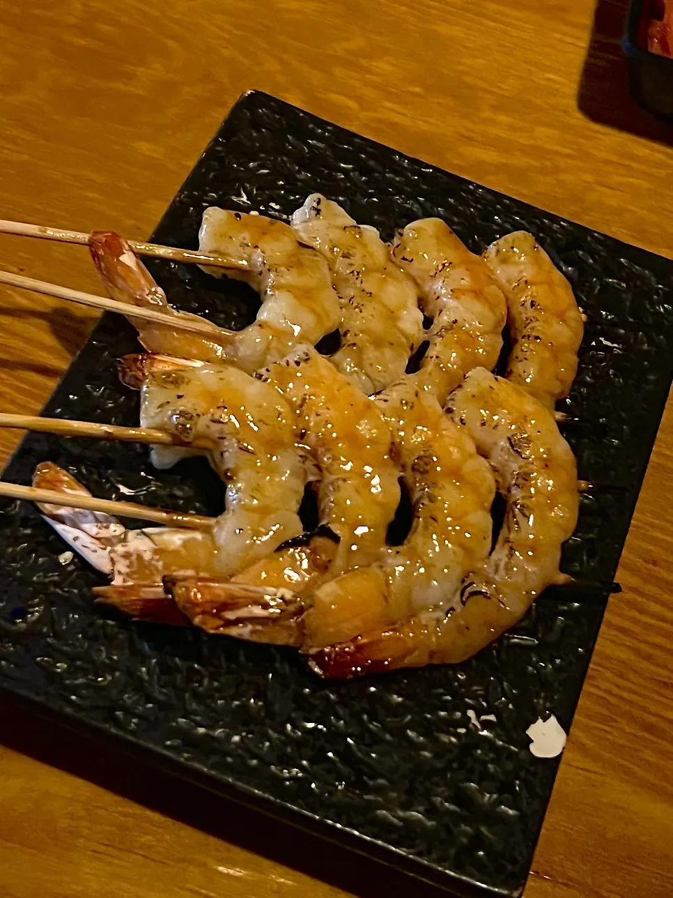 Glossy, plump charcoal-grilled shrimp