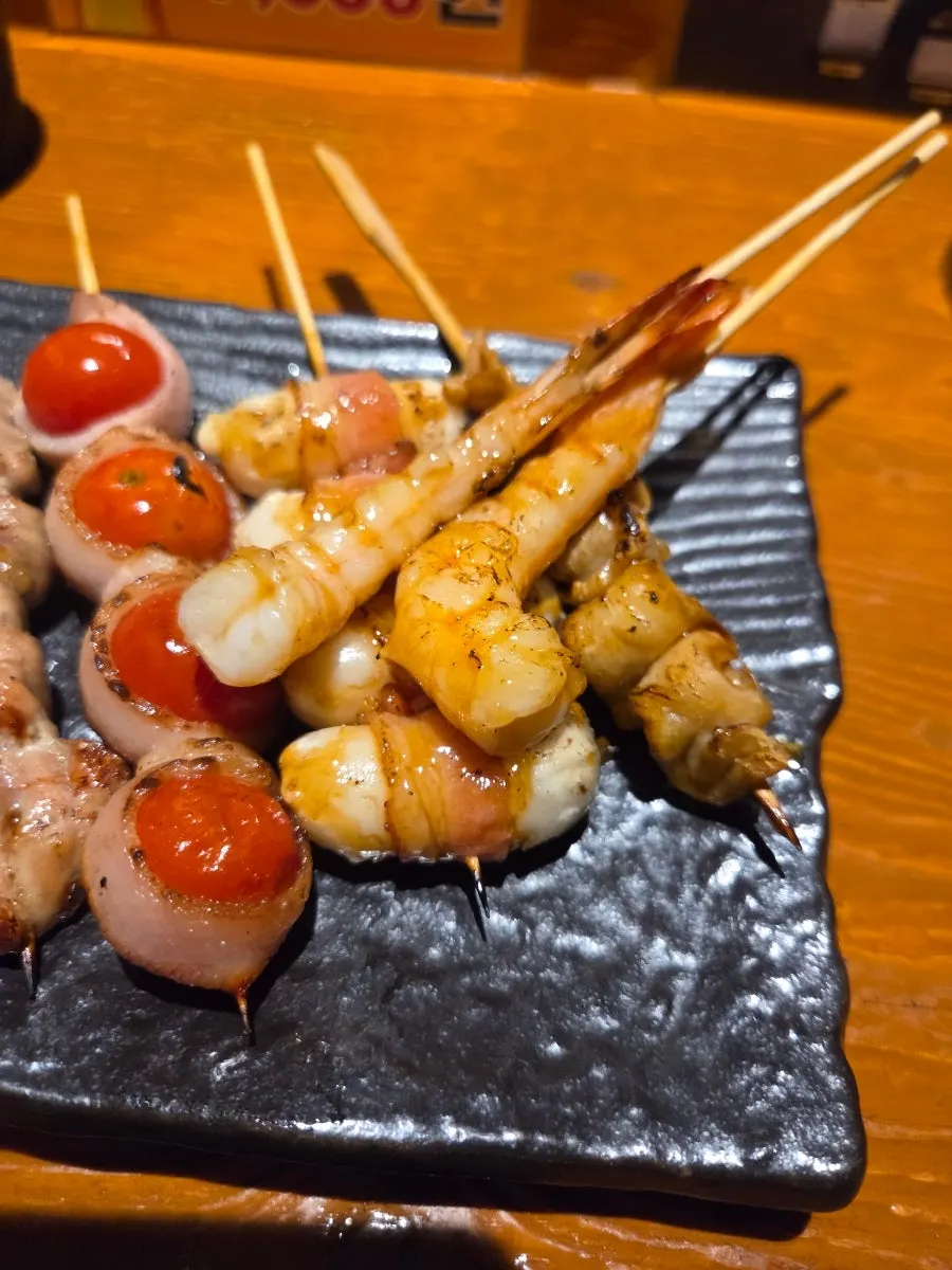 Bacon-wrapped rice cake and heart skewer among the mixed skewers