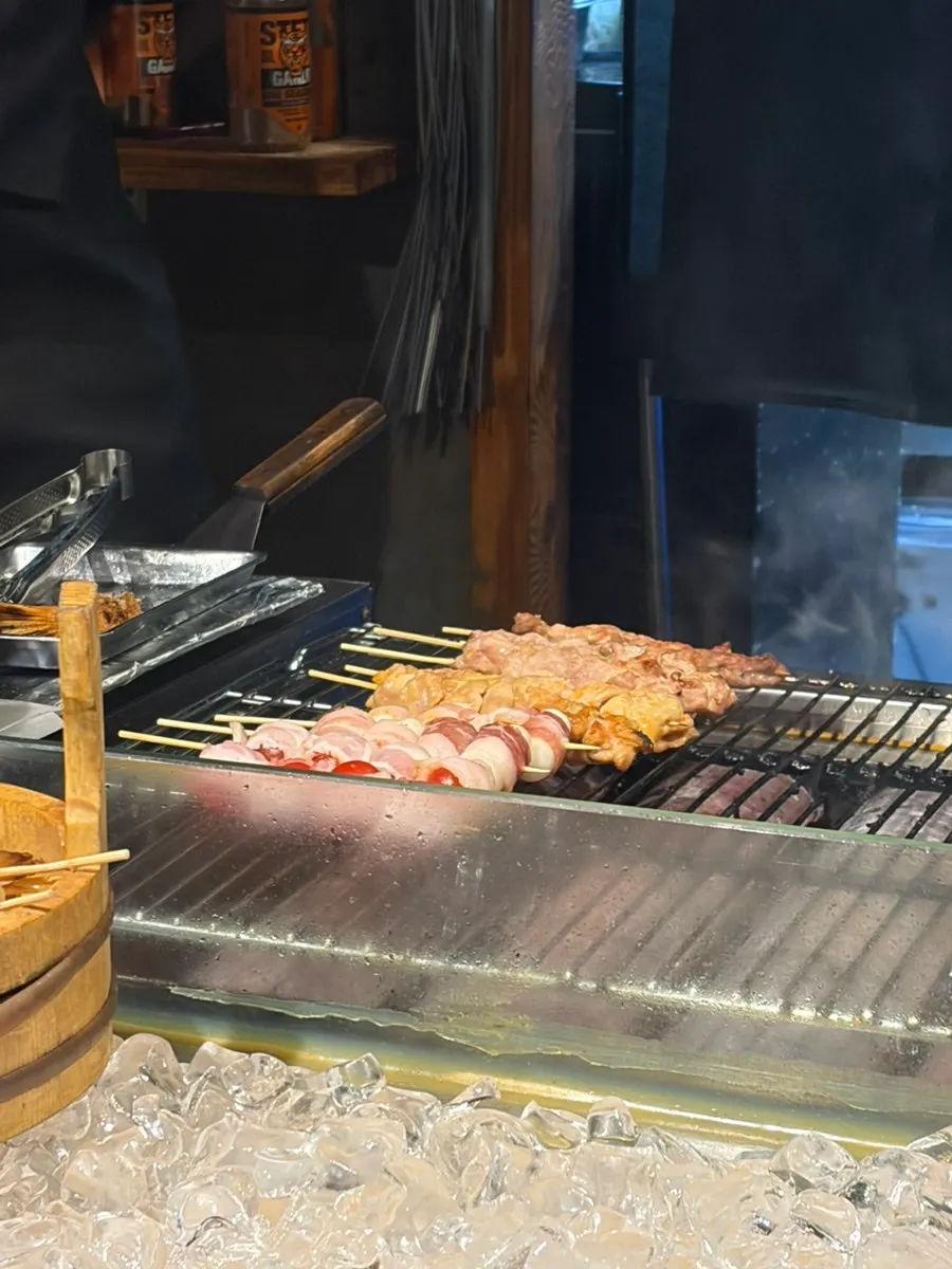 Robadayaki grilling station where fish and skewers are cooked directly