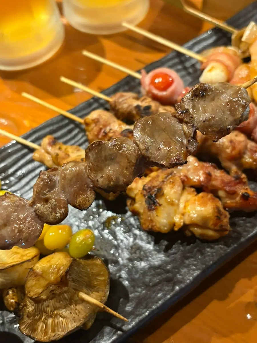Holding up one grilled skewer