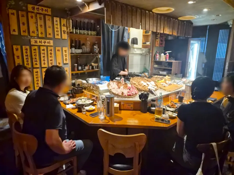 Skewer-grilling station in the middle of the restaurant