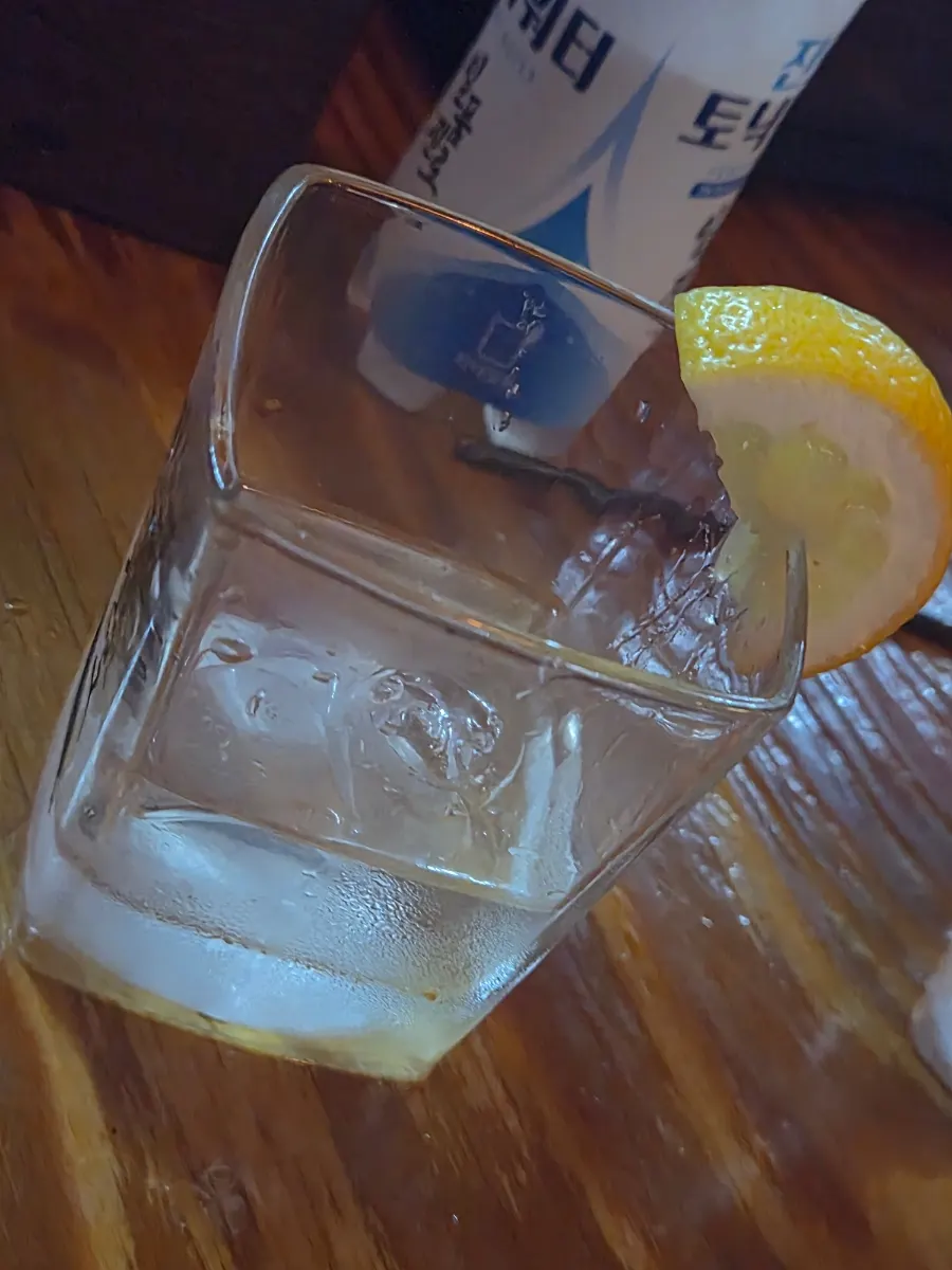 A couple joking around at the table while drinking