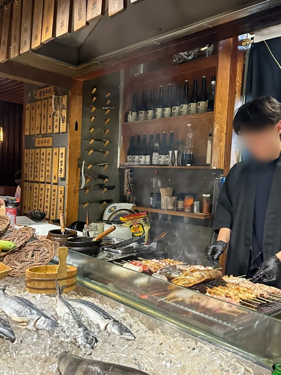 Skewers being grilled over charcoal