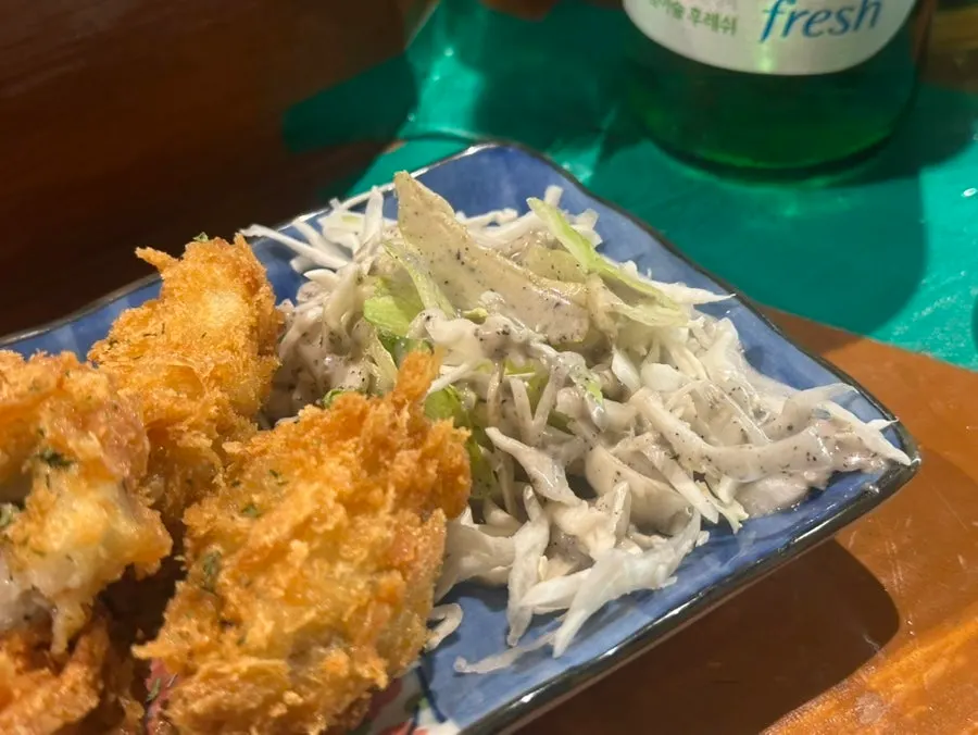 A bite of oyster fritter with cabbage