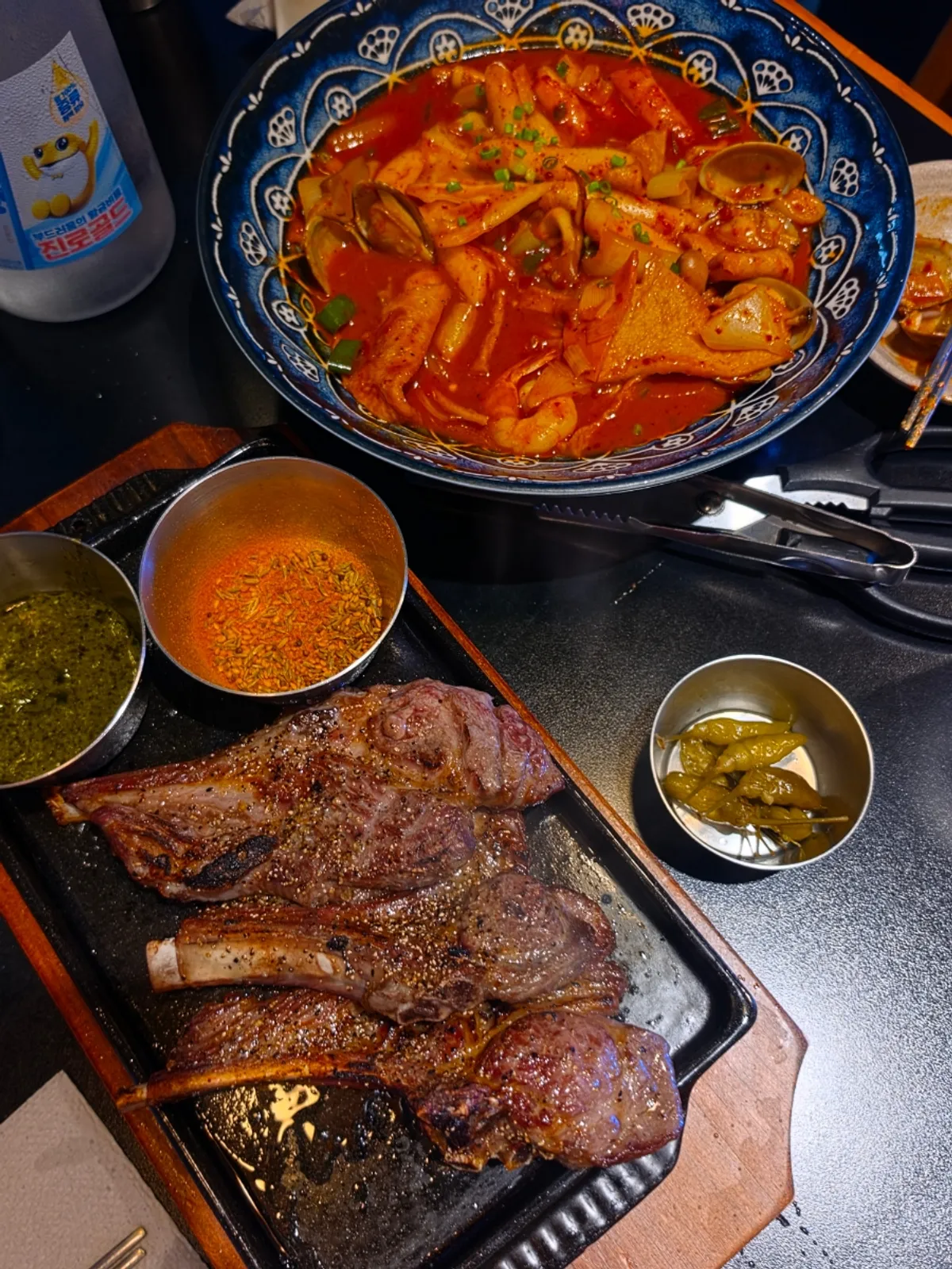 Sauces and spices served alongside the lamb