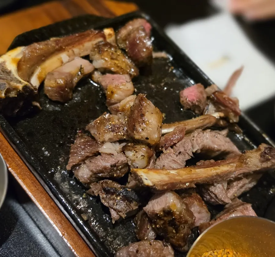 A piece of lamb dipped in sauce