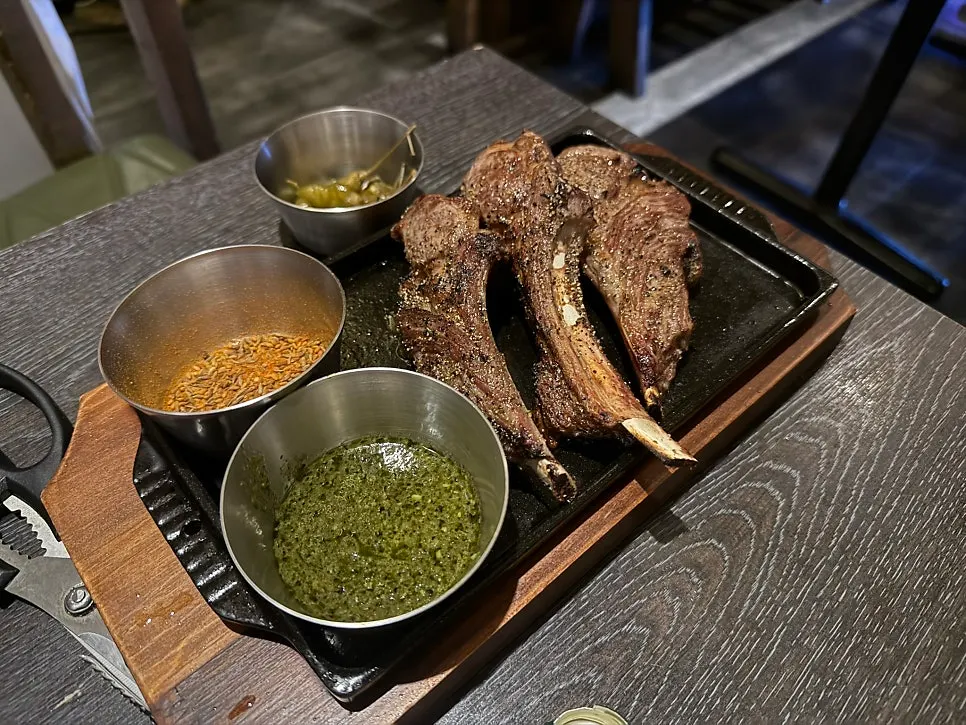 Three pieces of lamb shoulder rack on the grill plate