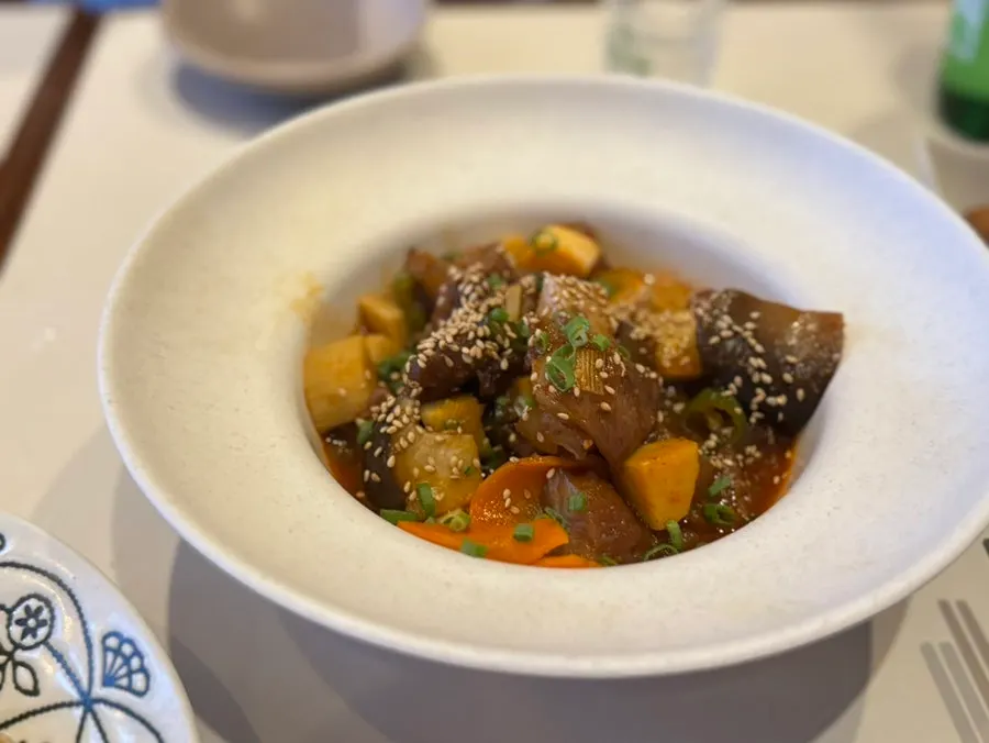 Close-up of tendon and vegetables braised in sauce